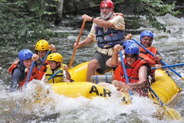 a group of people riding on a raft in the water
