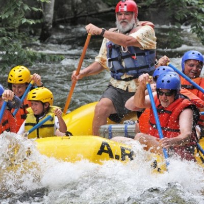 a group of people riding on a raft in the water