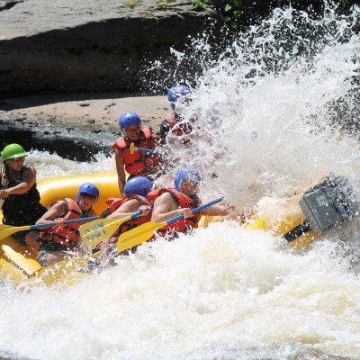 a group of people on a raft in a body of water