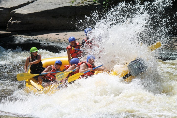 a group of people on a raft in a body of water