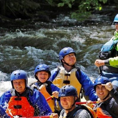 a group of people riding on a raft in a body of water