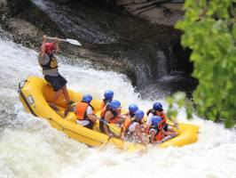 a group of people riding skis on a raft in the water