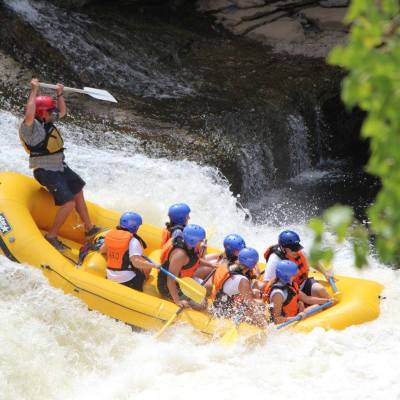 a group of people riding skis on a raft in the water