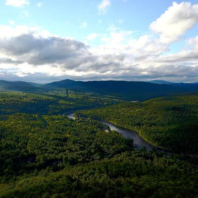 a large green field with a mountain in the background