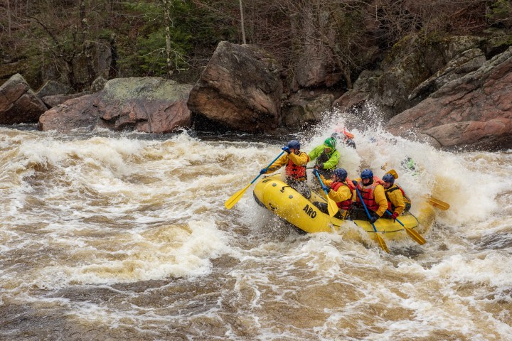 a man riding on a raft in a body of water