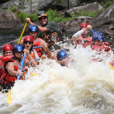 a group of people riding skis on a raft in a body of water