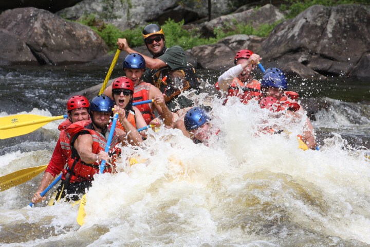 a group of people riding skis on a raft in a body of water