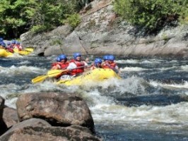 a person in a raft on a rock