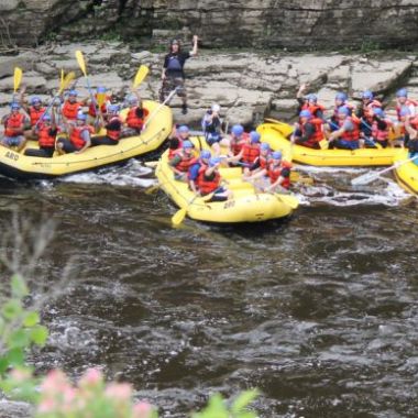 a group of people on a raft in a river