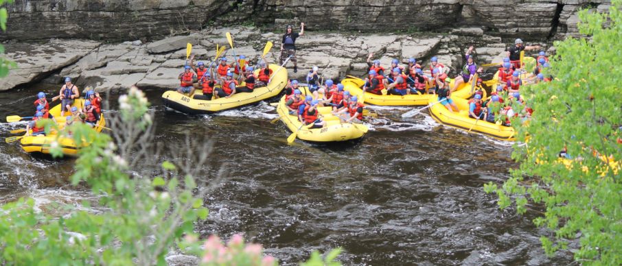 a group of people on a raft in a river