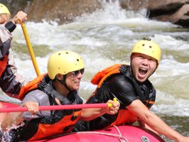 a group of people riding on a raft in a body of water