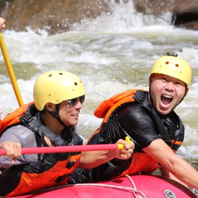 a group of people riding on a raft in a body of water