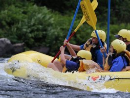 a person riding on the back of a boat