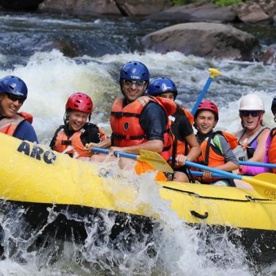 a group of people riding on a raft in the water