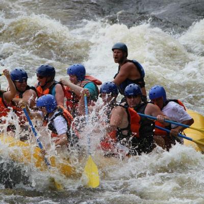 a group of people riding on a raft in the water