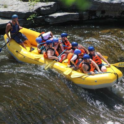 a group of people riding on a raft in a body of water