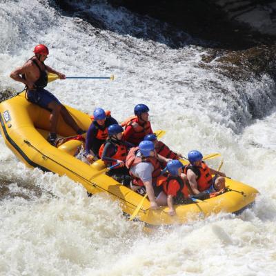 a group of people riding on the back of a boat in the water