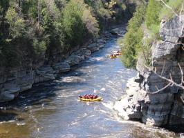 a group of people standing next to a waterfall