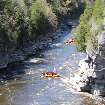 a group of people standing next to a waterfall