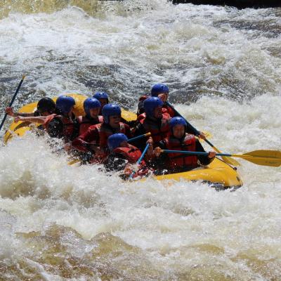 a group of people riding on a raft in a body of water